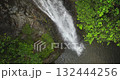 Fiji, Nadi Waterfall: close up stunning waterfall cascading down a rocky cliff, vibrant green canopy of lush rainforest. Breathtaking aerial view revealing wild nature landscape. Drone flight footage Fiji, Nadi Waterfall: close up stunning waterfall cascading down a rocky cliff, vibrant green canopy of lush rainforest. Breathtaking aerial view revealing wild nature landscape. Drone flight footage 132444256