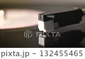 close up view of the turn table with the spinning vinyl disc and the needle 132455465