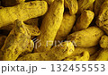 top view close up turmeric Curcuma yellow dried roots rotating background 132455553