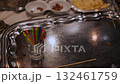 Colorful skewers left on a silver platter after a grand feast in a festive dining setting 132461759