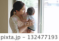 A woman holding a baby and healing 132477193