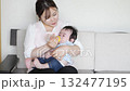A woman feeding her baby with a bottle 132477195