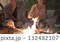 Mother and Daughter Roasting Marshmallows Over Backyard Fire 132482107