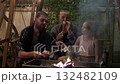 Family Roasting Marshmallows and Grilling on Cozy Backyard Evening 132482109
