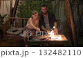 Father and Daughter Roasting Marshmallows Over Backyard Fire 132482110