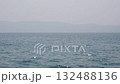 Beautiful sparkling sun reflections on light blue water surface. Continuously changing wavy sea surface with horizon for background. Neutral mirror effect, sun glittering around on the beach. 132488136