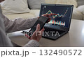 Asian man rejoicing at rising stock prices 132490572