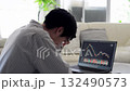Asian man feeling depressed after seeing stock prices fall 132490573