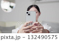 Asian woman taking a photo with a smartphone 132490575
