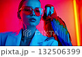 A woman wearing sunglasses with a parrot on her shoulder 132506399