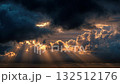 Dramatic sunset illuminating majestic clouds with crepuscular rays 132512176