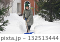 Caucasian elderly woman shoveling snow.  132513444
