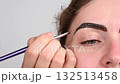 Caucasian woman getting eyebrow tinting procedure.  132513458