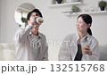 Asian men and women drinking protein in the living room 132515768