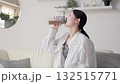 Asian woman drinking protein in the living room 132515771