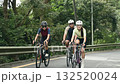 young asian cyclists riding bike on rural road	 132520024