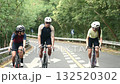 three young asian cyclists riding bicycle on a uphill country road	 132520302
