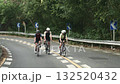 three young asian cyclists riding bicycle on a uphill country road	 132520432