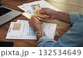 Man dressed in shirt holds several 50 euro bills carefully organizing banknotes in hands at table accountant calculates entire amount of expenses slow motion 132534649