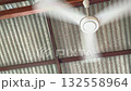 spinning of white ceiling fan hang from roof daytime 132558964