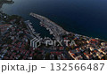 Aerial drone video of the marina and coastal town of Kas at sunrise, showing boats, pier, and calm blue sea. Turkey 132566487