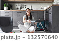Young woman sitting on the floor assembling a chair with tools. Concept of female independence and do it yourself lifestyle. 132570640