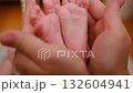 Baby feet in mother hands. Tiny Newborn Baby's feet on hands closeup. 132604941