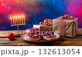 Cozy festive Hanukkah display with sufganiot, menorah, and wrapped gifts set against a colorful background 132613054