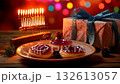 Cozy festive Hanukkah display with sufganiot, menorah, and wrapped gifts set against a colorful background 132613057