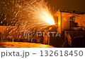 sparks blasting from cutter at night, bright orange embers fan from open chamber onto metal piles; gritty scrapyard cutting, grinder action, debris scattering, machine glow and heavy duty 132618450