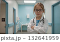 Young girl dressed as doctor standing confidently in hospital hallway. 132641959