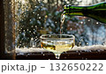 Champagne Pouring Into a Glass by the Window on a Snowy Day 132650222
