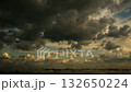 Dramatic Sunset Clouds Over a Serene Landscape at Dusk 132650224