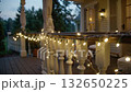 Outdoor Porch Decorated With Warm String Lights During Twilight Hours 132650225