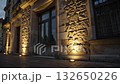 Illuminated Stone Wall in City at Dusk Showcasing Architectural Details and Warm Lighting Effects 132650226