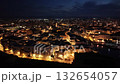Night flight over the illuminated historic center, port, and castle of Monopoli, Italy 132654057