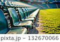 Close-up of worn, empty stadium seats in warm sunlight. A nostalgic image of waiting, past memories, and the anticipation for the next season. 132670066
