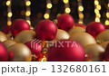This vibrant collection of red and gold Christmas ornaments is beautifully set against soft bokeh lights, evoking a warm holiday spirit perfect for celebration and festive gatherings 132680161