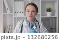 In a contemporary office setup, a healthcare professional donning a pristine lab coat elaborates on important medical items and actively engages with the camera to improve viewer understanding 132680256