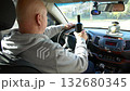 Drunk driving. The driver of the car is drinking a strong alcoholic beverage while driving. The driver drinks strong alcohol while driving. 132680345