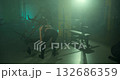 female athlete lifts weights as she performs deadlifts in a well equipped gym. The dim lighting creates an intense atmosphere emphasizing her strength and determination. 132686359