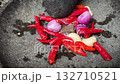 The making of chili paste called sambal , grinding red chili peppers, onion, and garlic in a rough stone mortar and pestle on a cobblestone surface, conveying rustic cooking and fresh spices, The making of chili paste called sambal , grinding red chili peppers, onion, and garlic in a rough stone mortar and pestle on a cobblestone surface, conveying rustic cooking and fresh spices, 132710521