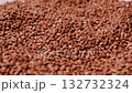 Detailed macro footage of raw buckwheat groats gently rotating under soft lighting 132732324