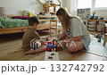 Mother and son painting together on floor in children's room 132742792