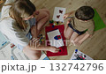 Mother and son painting together on the floor 132742796