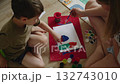 Mother and son painting colorful pictures on the floor 132743010