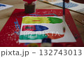 Colorful painting process with brush strokes on paper 132743013