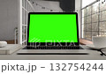 Greenscreen display on laptop set on white table. Home office workspace. Close up of chroma key on screen for Video Call, Website Template Presentation Game Applications. Freelance Business. Zoom in 132754244