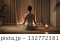 A quiet night yoga meditation scene with a flickering candle flame creating a soothing loop 132772381