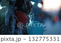 christmas tree lights illuminating snowy ornaments winter outdoors. closeup. 132775331